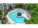 Aerial view of a community pool surrounded by lush landscaping and lounge chairs at 390 17Th Nw St # 4063, Atlanta, GA 30363