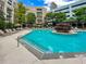 Large community pool with lounge seating surrounded by trees at 390 17Th Nw St # 4063, Atlanta, GA 30363