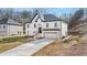 White two-story house with a gray roof and a long driveway at 4410 Ross Estates Ct, Snellville, GA 30039
