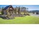 Stone Mountain Crest community entrance with wooden pavilion, lush lawn, and landscaping provides an impressive welcome at 2475 Barley Crest Pass, Cumming, GA 30040