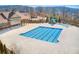 Large community pool with slide and tanning pool next to the clubhouse, providing a resort-like amenity for residents at 2475 Barley Crest Pass, Cumming, GA 30040