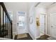 Bright entryway with staircase, hardwood floors, and access to powder room at 2475 Barley Crest Pass, Cumming, GA 30040