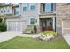 Townhouse exterior with landscaping, double garage, and front entry at 2475 Barley Crest Pass, Cumming, GA 30040