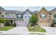 Two-story townhome with attractive landscaping and a two-car garage at 2475 Barley Crest Pass, Cumming, GA 30040