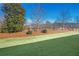 Beautifully maintained lawn and landscaping features a mix of mature trees and green grass, perfect for outdoor enjoyment at 2475 Barley Crest Pass, Cumming, GA 30040