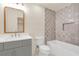 Bathroom with gray tile, a shower/tub combo, and a vanity at 702 Fairgate Rd, Marietta, GA 30064