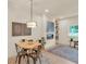 Bright dining area with a round table, four chairs, and a modern light fixture at 702 Fairgate Rd, Marietta, GA 30064