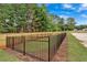 Enclosed dog park with artificial turf and black metal fencing at 702 Fairgate Rd, Marietta, GA 30064