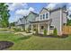 Three townhomes with gray and green siding, metal roofs, and a shared lawn at 702 Fairgate Rd, Marietta, GA 30064