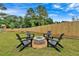 Relaxing fire pit area with four black Adirondack chairs at 702 Fairgate Rd, Marietta, GA 30064