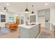 Open-plan kitchen and living area with gray island and leather sofa at 702 Fairgate Rd, Marietta, GA 30064