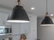 Close-up view of modern black pendant lights above kitchen cabinets at 702 Fairgate Rd, Marietta, GA 30064