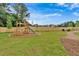 Community playground with playset, swings, and picnic tables at 702 Fairgate Rd, Marietta, GA 30064