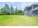 Large backyard with lush green grass and mature trees at 5649 Eagles Watch, Douglasville, GA 30135