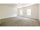 Spacious bedroom with neutral carpet and two windows at 5649 Eagles Watch, Douglasville, GA 30135