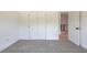 Bright bedroom featuring neutral wall and carpet, and double door closet at 5649 Eagles Watch, Douglasville, GA 30135