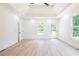 Spacious primary bedroom with high ceilings, wood-look floors, and access to deck at 5649 Eagles Watch, Douglasville, GA 30135
