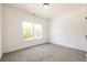 Spacious bedroom with neutral carpeting and large window at 5649 Eagles Watch, Douglasville, GA 30135