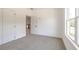 Well-lit bedroom with carpet, window, and door to hallway at 5649 Eagles Watch, Douglasville, GA 30135