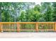 Deck with wooden railings overlooking lush green trees at 5649 Eagles Watch, Douglasville, GA 30135