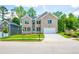 Two-story brick home with a white garage door and landscaped lawn at 5649 Eagles Watch, Douglasville, GA 30135