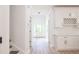 Light-filled hallway with white walls and hardwood floors at 5649 Eagles Watch, Douglasville, GA 30135