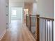 Bright hallway with hardwood floors and modern railing overlooking the lower level at 5649 Eagles Watch, Douglasville, GA 30135
