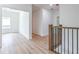 Upstairs hallway with wood-look floors and access to bedrooms at 5649 Eagles Watch, Douglasville, GA 30135