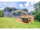Two story home with gray siding, deck and sloped backyard at 5649 Eagles Watch, Douglasville, GA 30135