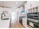 Modern kitchen with island, stainless steel appliances, and white cabinets at 5649 Eagles Watch, Douglasville, GA 30135