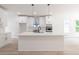 Modern kitchen with island, stainless steel appliances, and white cabinets at 5649 Eagles Watch, Douglasville, GA 30135