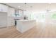 Open concept kitchen and living area with hardwood floors and an island at 5649 Eagles Watch, Douglasville, GA 30135