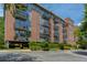 Brick building exterior with balconies and landscaped grounds at 640 Glen Iris Ne Dr # 303, Atlanta, GA 30308