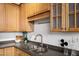Modern kitchen featuring light wood cabinets and a double sink at 640 Glen Iris Ne Dr # 303, Atlanta, GA 30308