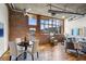 Open living area features hardwood floors, exposed brick, and large windows at 640 Glen Iris Ne Dr # 303, Atlanta, GA 30308