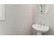 Small powder room with pedestal sink and round mirror at 1708 Evenstad Way, Smyrna, GA 30080
