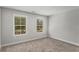 Spacious bedroom with two windows and neutral wall colors at 1708 Evenstad Way, Smyrna, GA 30080