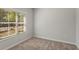 Simple bedroom with neutral walls, carpeted floor, and window with blinds at 1708 Evenstad Way, Smyrna, GA 30080