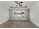 Bright bedroom with large window, ceiling fan, and plush carpeting at 1708 Evenstad Way, Smyrna, GA 30080