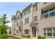 Row of beige brick townhomes with gray shutters and white columns at 1708 Evenstad Way, Smyrna, GA 30080
