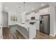 Modern kitchen with white cabinets, stainless steel appliances, and quartz countertops at 1708 Evenstad Way, Smyrna, GA 30080