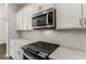 Modern kitchen features with white cabinets and stainless steel appliances at 1708 Evenstad Way, Smyrna, GA 30080