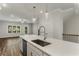 Kitchen island with white cabinets, quartz countertop, and modern sink at 1708 Evenstad Way, Smyrna, GA 30080