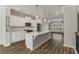 Open kitchen with white cabinets, large island, and hardwood floors at 1708 Evenstad Way, Smyrna, GA 30080