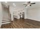 Open living room with hardwood floors, kitchen island, and modern staircase at 1708 Evenstad Way, Smyrna, GA 30080