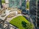 An expansive green plaza with people relaxing, surrounded by modern buildings at 1708 Evenstad Way, Smyrna, GA 30080