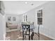 Bright dining area with glass table and four chairs, adjacent to living room at 1766 Blossom Ln, Austell, GA 30168