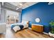 Bright bedroom with blue accent wall and wood dresser at 260 18Th Nw St # 10311, Atlanta, GA 30363