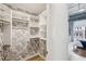 Walk-in closet with patterned wallpaper and shelving at 260 18Th Nw St # 10311, Atlanta, GA 30363