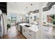 Open concept kitchen with white island, stainless steel appliances, and hardwood floors at 260 18Th Nw St # 10311, Atlanta, GA 30363